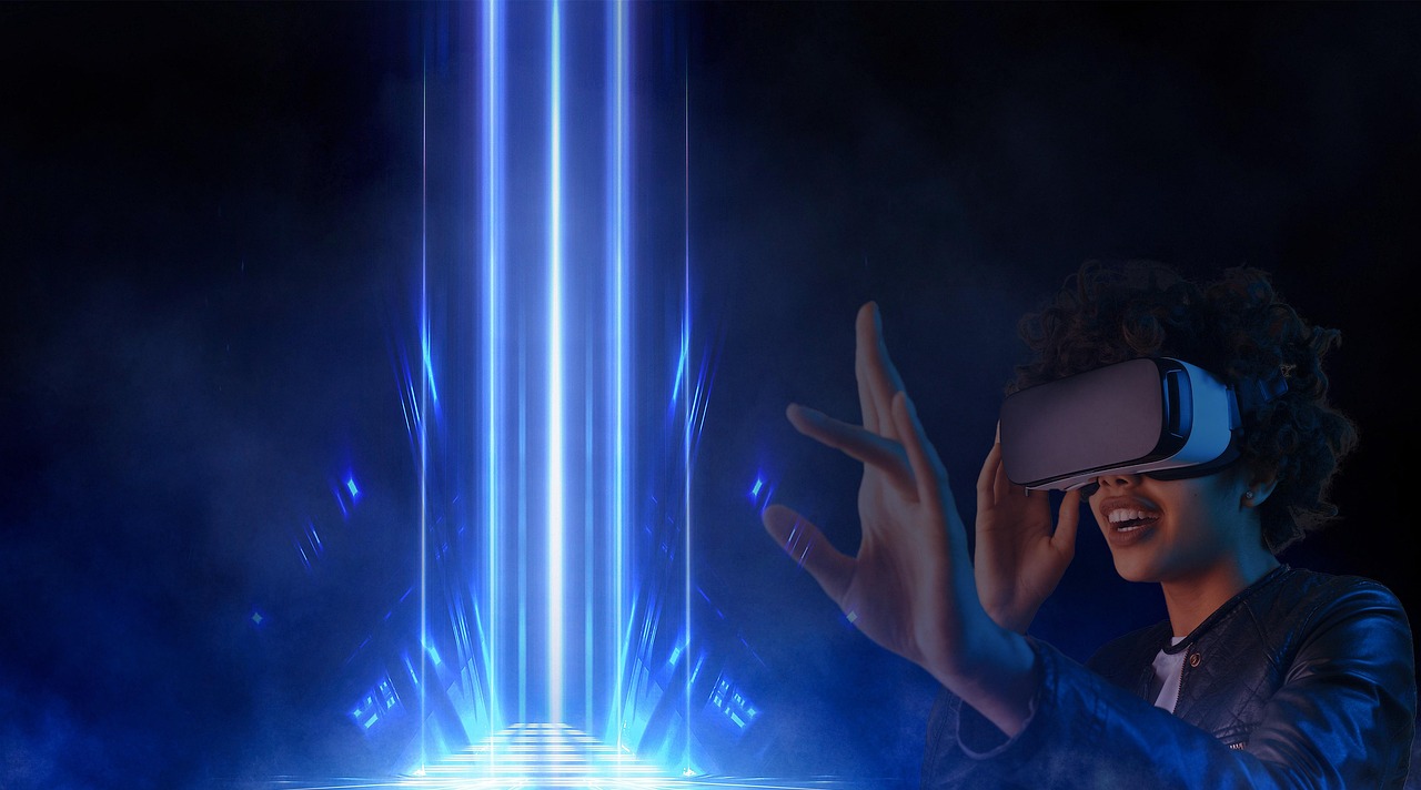 A person in a VR headset reaching toward a column of blue light.